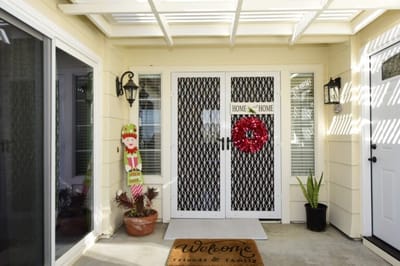 Entrance with a welcome mat and festive decor