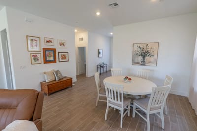 Bright common area with dining table and artwork