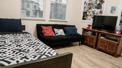 A cozy resident room with a bed and seating area