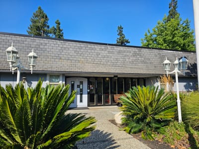 Exterior view of the Bethesda Home entrance under blue skies