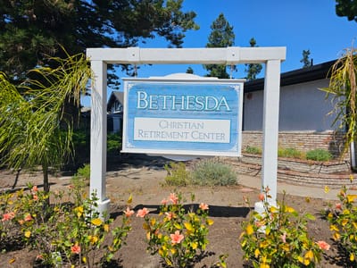 Sign for Bethesda Christian Retirement Center in a garden setting
