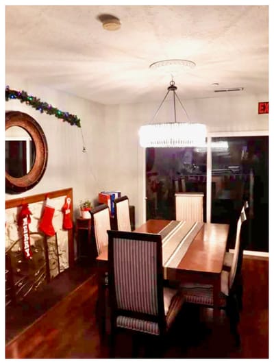 Dining area with festive decorations and a large chandelier