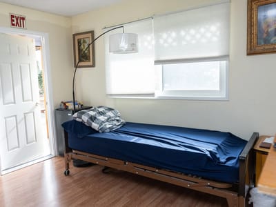 A private resident room with a bed and natural light