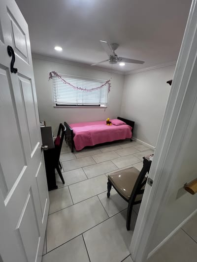 Cozy resident room with pink bedding and a tidy layout