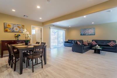 Bright and spacious common area with seating and dining table