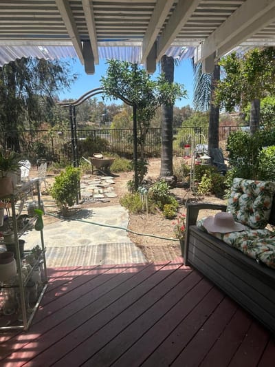 Garden view from a porch with seating