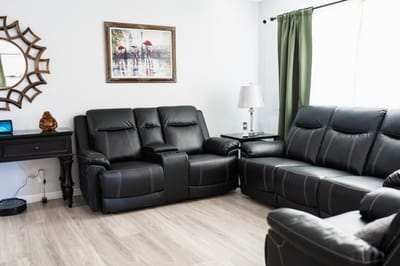 Cozy common area with reclining sofas and art