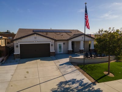 Exterior view of a senior living facility with an American flag