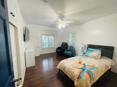 Well-furnished private room with a bed and seating area