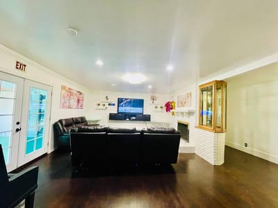 Bright living area with dark furniture and television