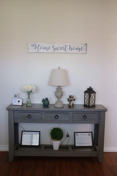 Decorative console table with a lamp and flowers
