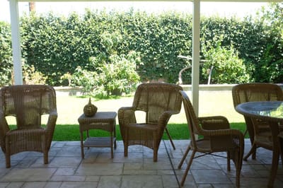 Outdoor seating area with wicker chairs and table