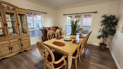 Bright dining room with wooden furniture and plants