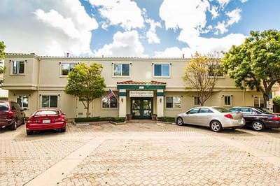 Exterior view of Burlingame Villa with parking area