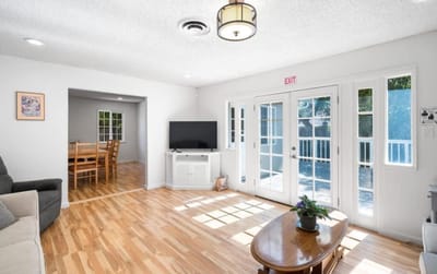 Bright common area with wood flooring and seating