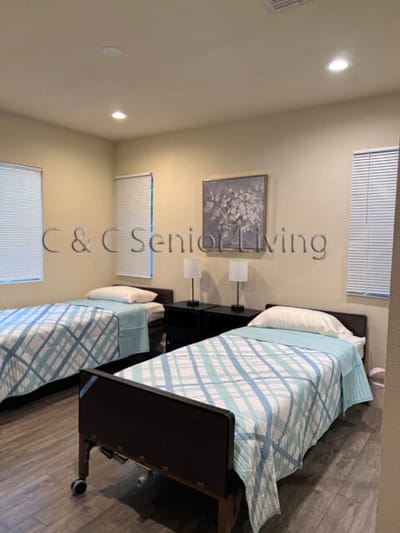 A shared bedroom with two beds in a senior living facility