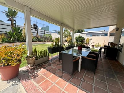 Outdoor seating area with plants and tables