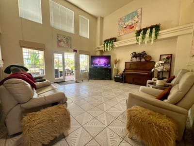 Bright interior common area with seating and piano