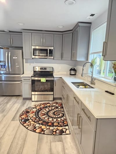 Modern kitchen with gray cabinets and decorative rug