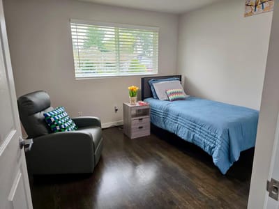 A well-furnished private resident room with natural light