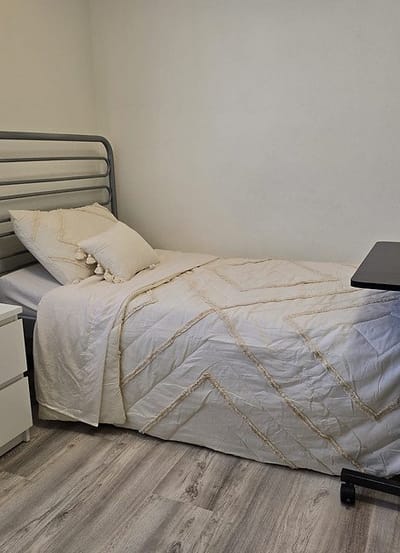 Private resident room with a bed and desk
