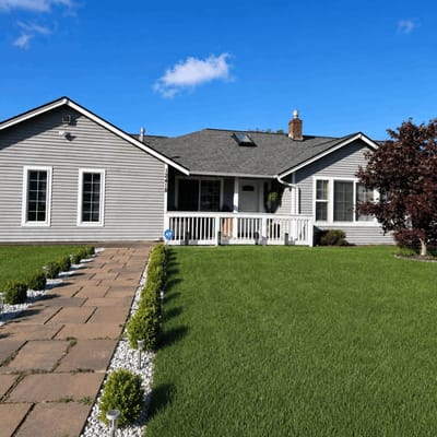 Exterior view of a senior living facility with a well-kept lawn