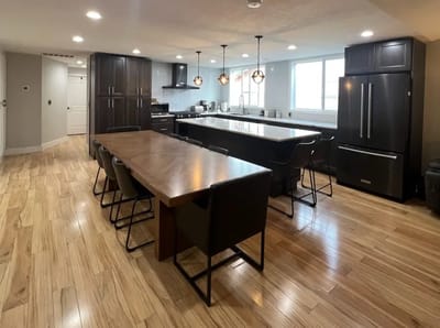 Modern kitchen space with wooden flooring and dining area