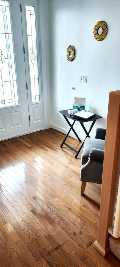 Bright interior area with hardwood floor and small table