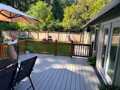 Outdoor patio area with seating and greenery