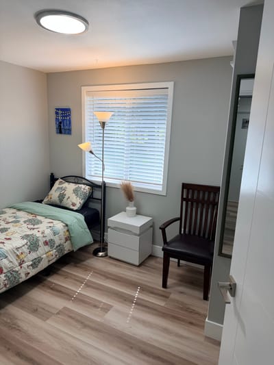 Cozy private resident room with bed and chair
