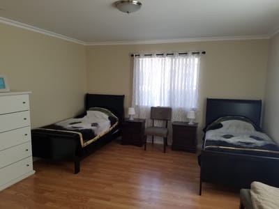 Cozy resident room with two beds and natural light