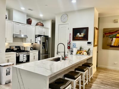 Modern kitchen interior with marble countertops and seating