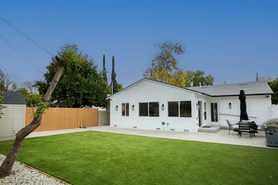 Exterior view of a white building and green lawn