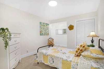 Bright and cozy resident bedroom with floral bedding