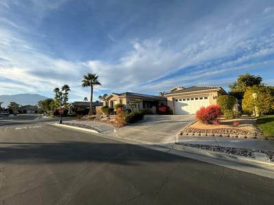 Exterior view of a senior living facility with landscaped yard