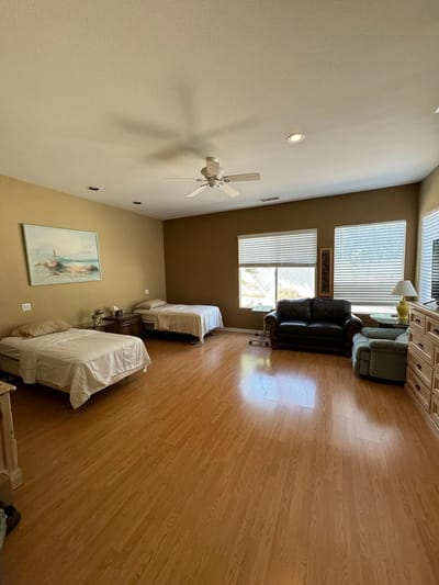 Bright and spacious resident room with twin beds and cozy seating