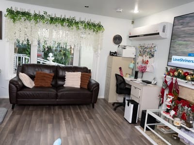 Common area with a couch, desk, and decorative elements