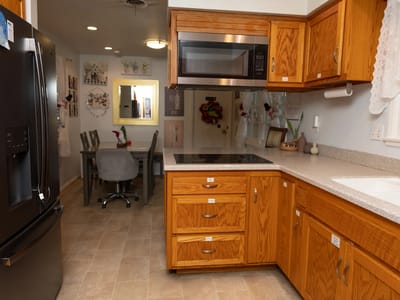 Well-equipped kitchen with dining area visible