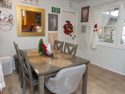 Brightly decorated dining area with table and holiday decor