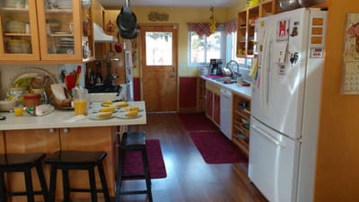 A cozy kitchen with plates of food and wooden cabinets
