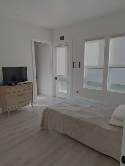 Cozy interior of a resident's room with a bed and TV