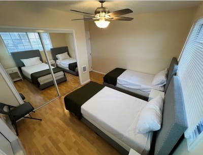 Private resident room with two beds and bright lighting