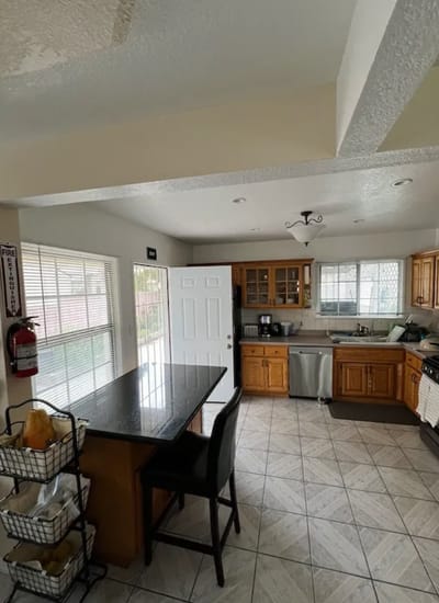 Modern kitchen with wooden cabinets and a black countertop