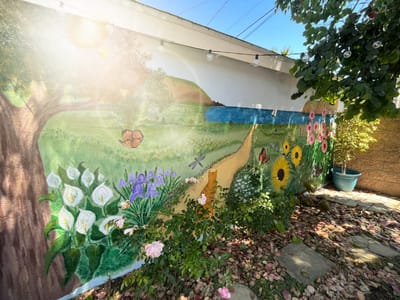 A colorful mural depicting a garden scene