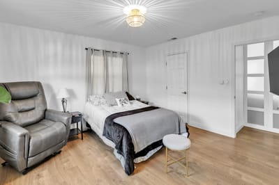 Cozy private resident room with a bed and chair