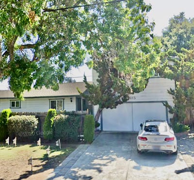 Exterior view of Casa Pastel Care Home with trees and vehicle