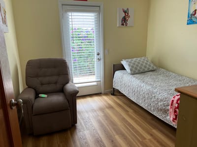 Private resident room with a bed and recliner