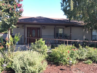 Exterior view of Casa Pastel Care Home with garden