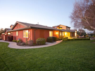 Exterior view of Casa Rosa Elder Care facility at sunset