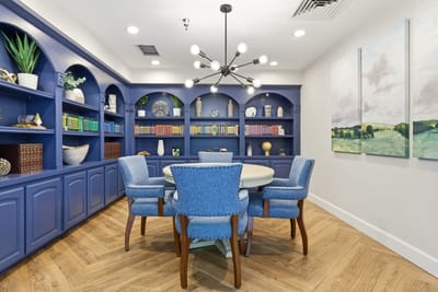Bright common area with a blue bookcase and seating